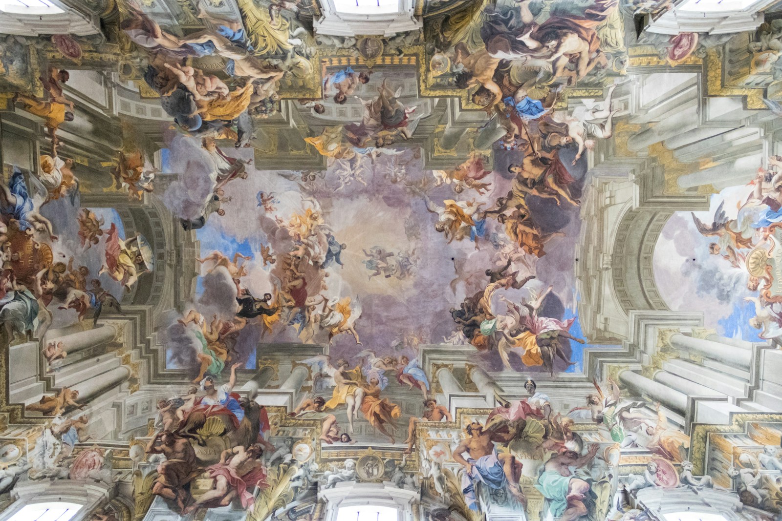 the ceiling of a building with many paintings on it