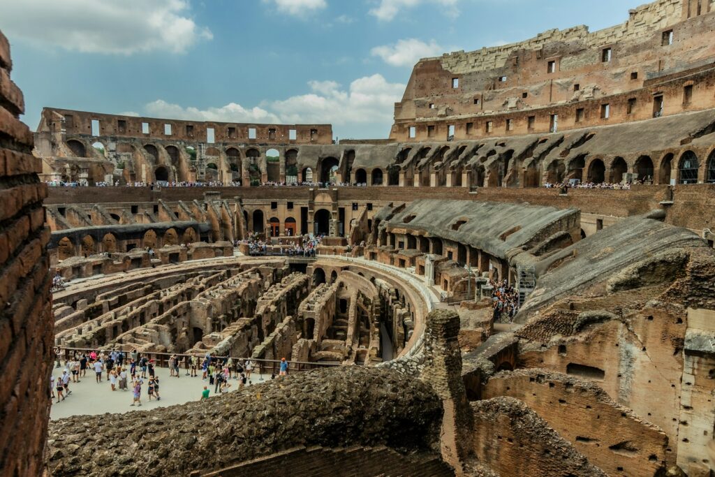 The interior of an old building with people walking around